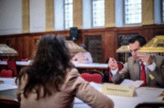 Two people sitting opposite to each other for a consulatation.